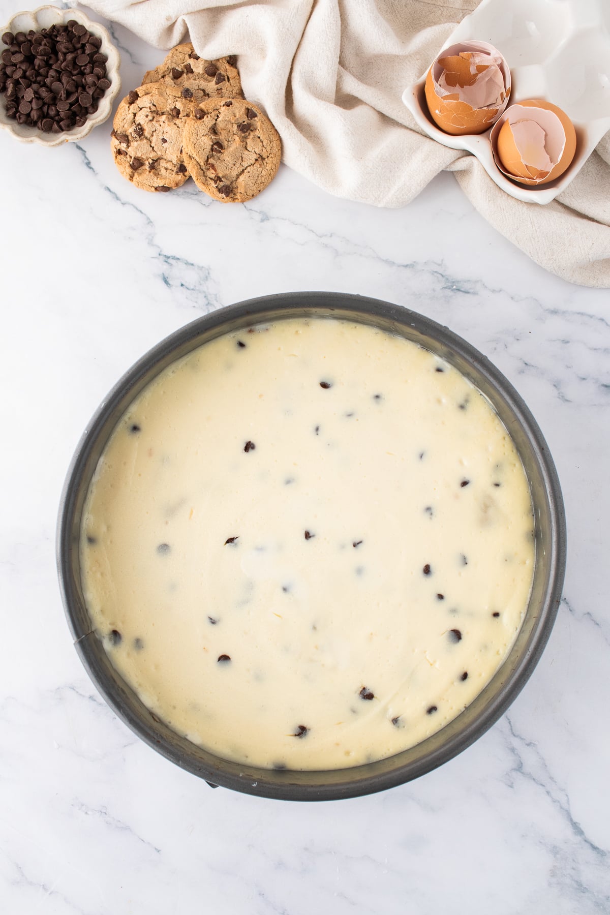 The cheesecake cooked and cooling in a springform pan.