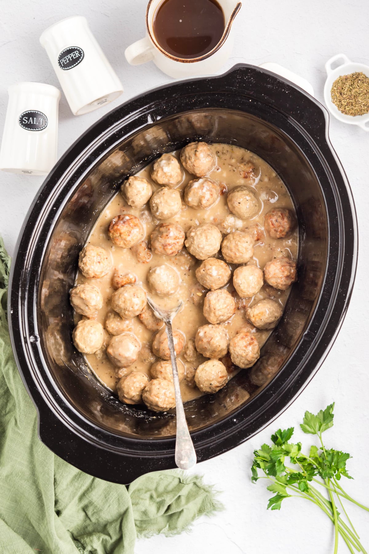 Frozen meatballs added to the crockpot.