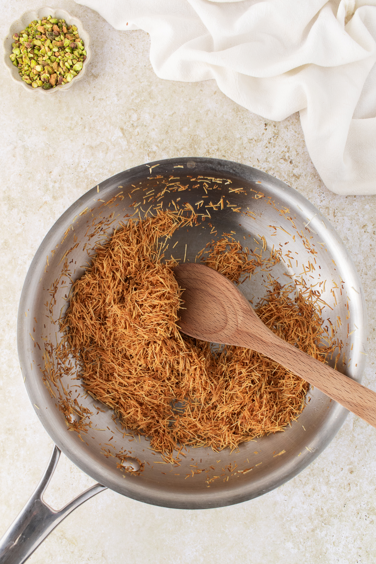 Kataifi toasted in a skillet. 