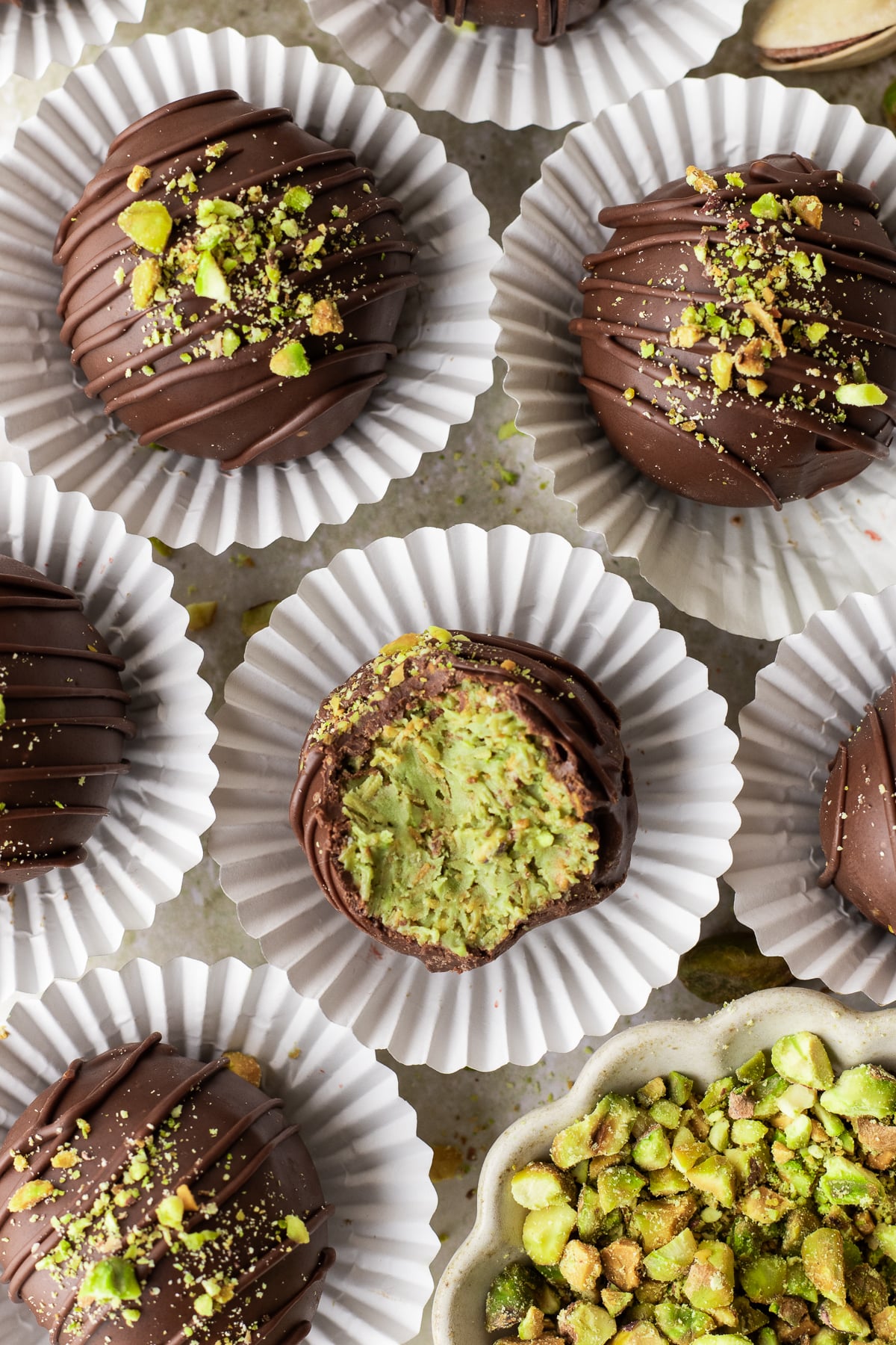 Truffles on cookie wrappers and one with a bite taken out of it.