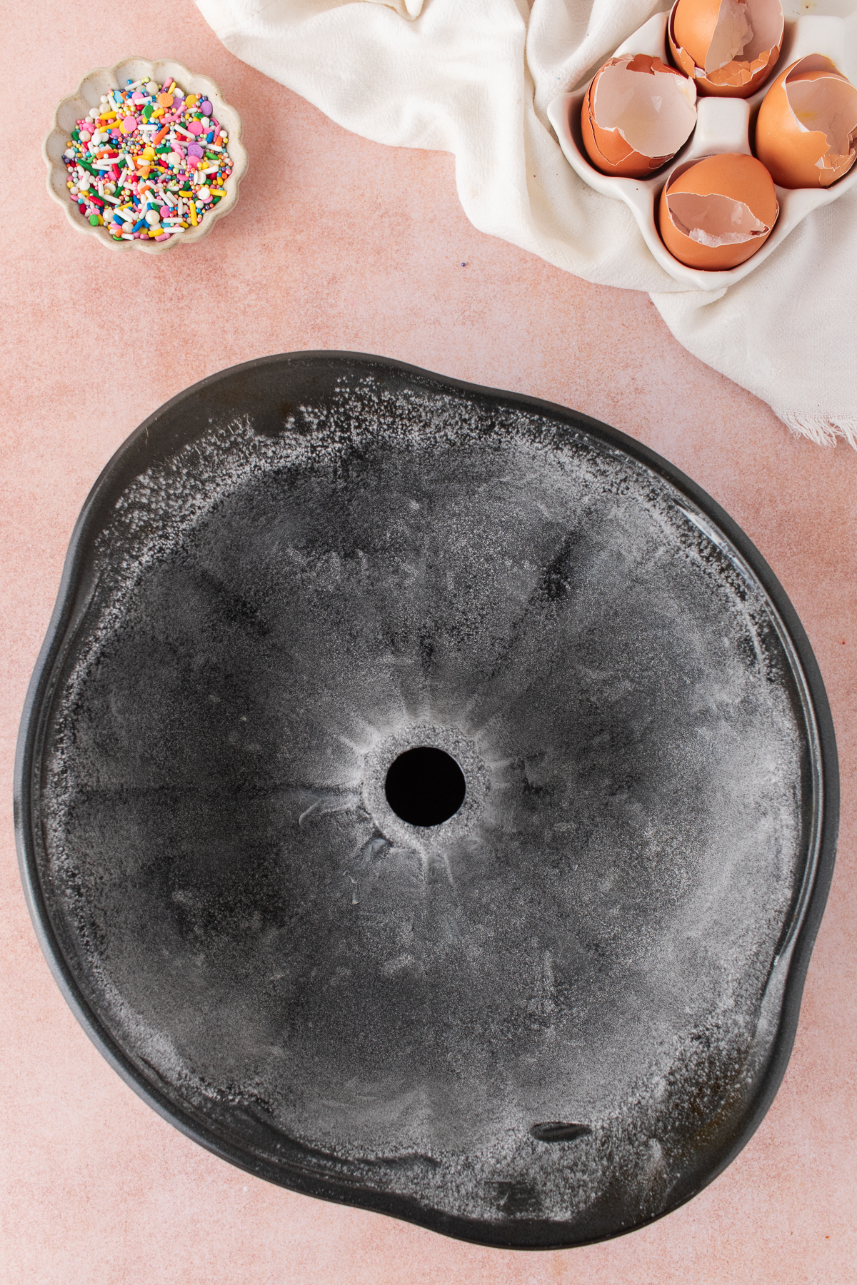 A bundt cake pan greased on a table.