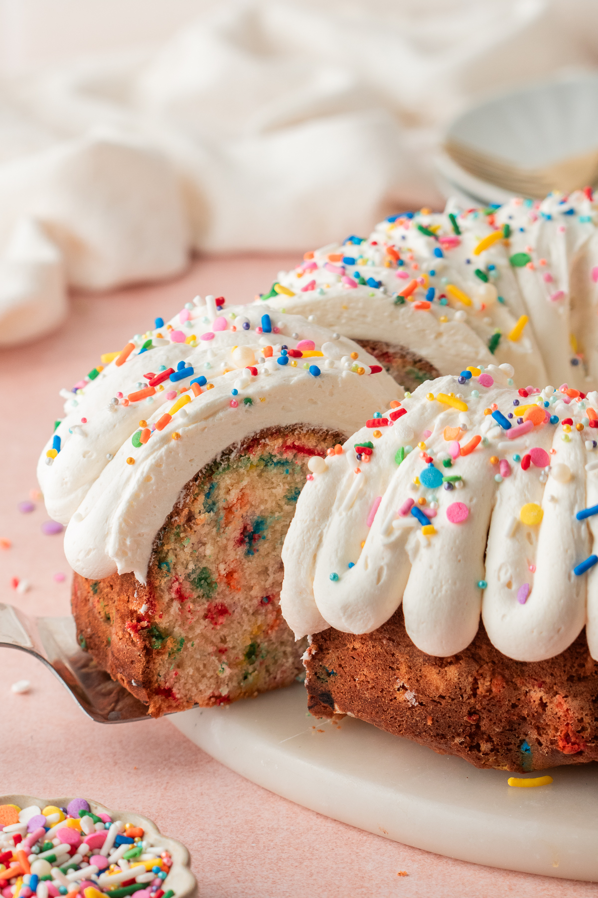 A slice of funfetti bundt cake with sprinkles.