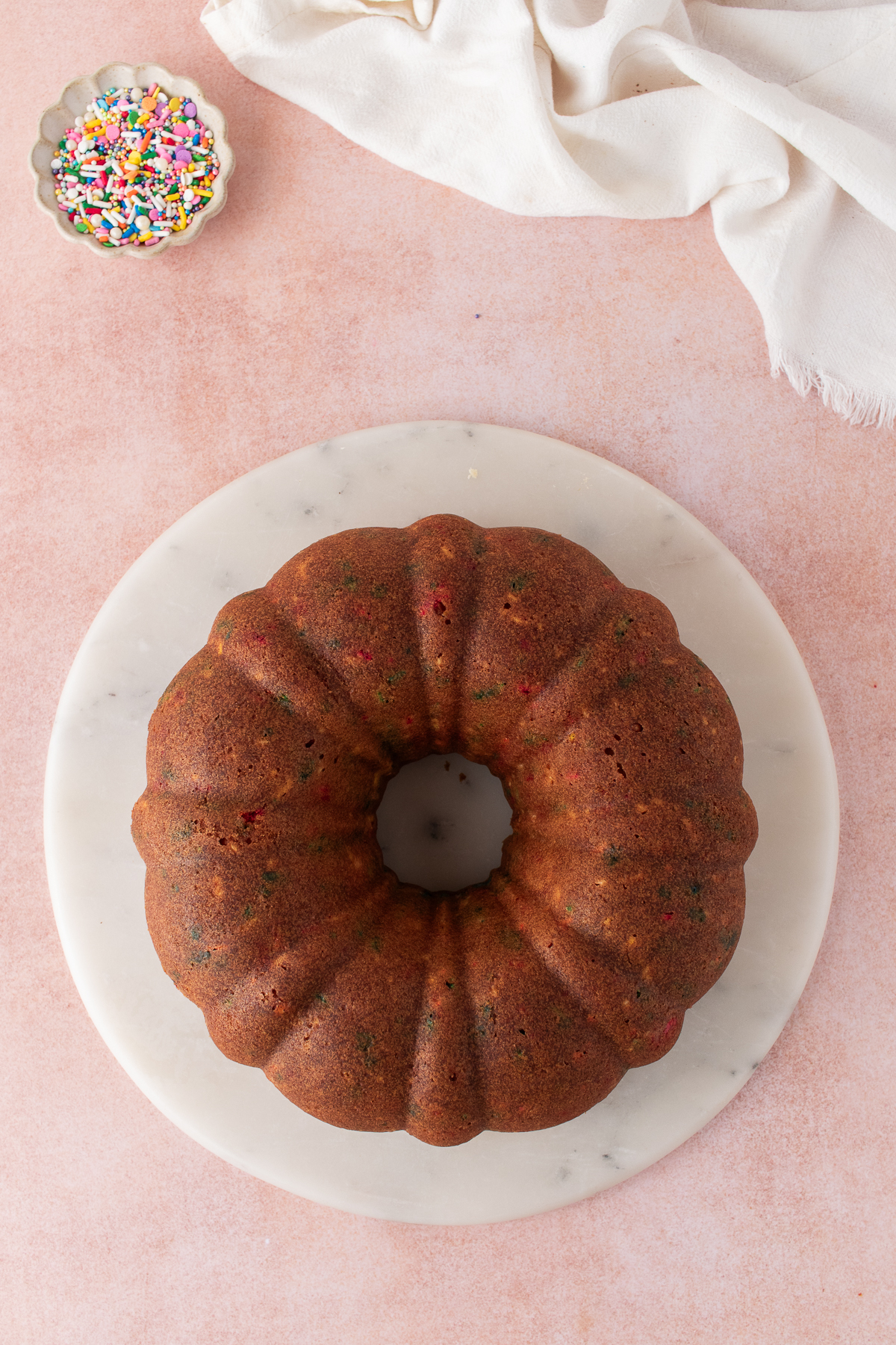 The bundt cake cooled and flipped on a plate.