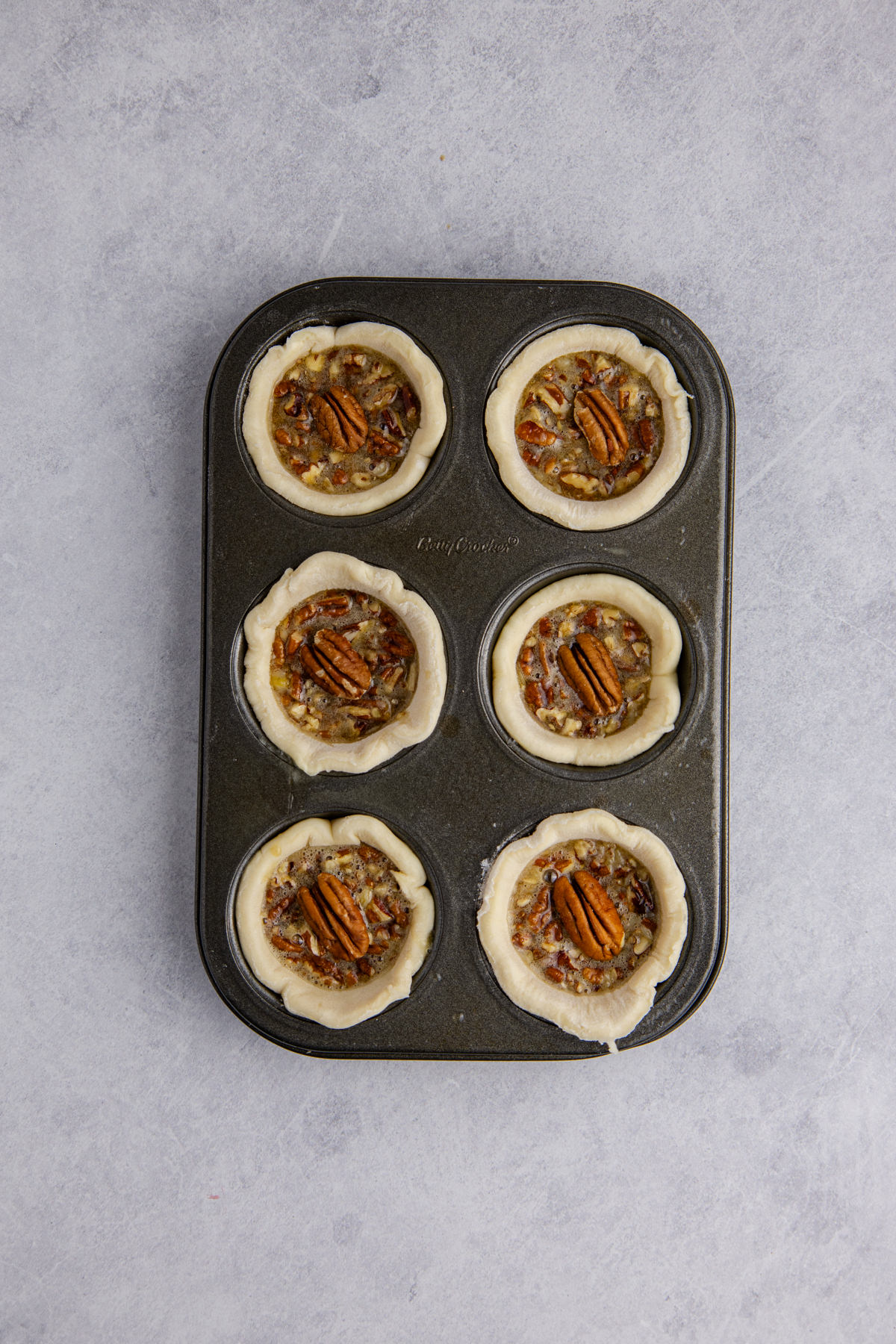 Filling is added to muffin pan.