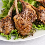 Pan seared lamb chops on a bed of lettuce.