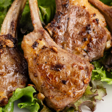 Pan seared lamb chops on a bed of lettuce.