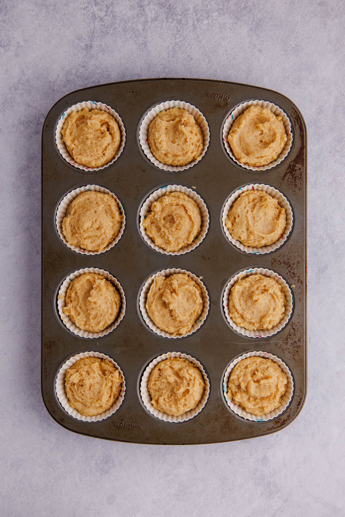The peanut butter muffin batter added into a muffin tin.