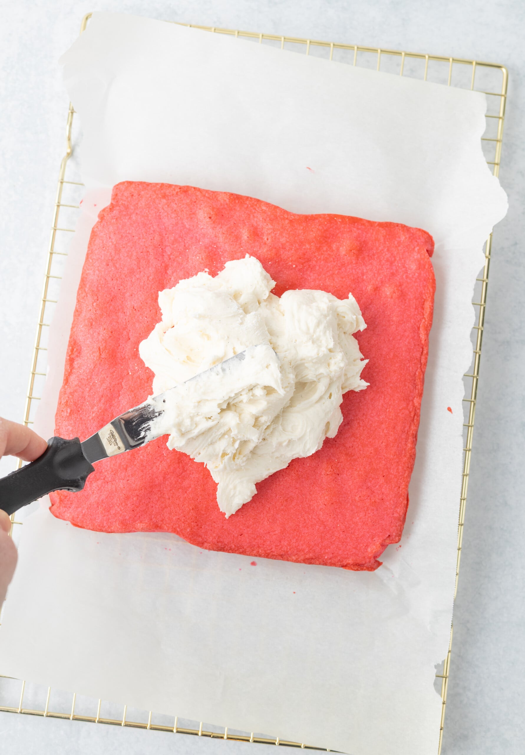 Cream cheese frosting spread over top of the cooled brownies.