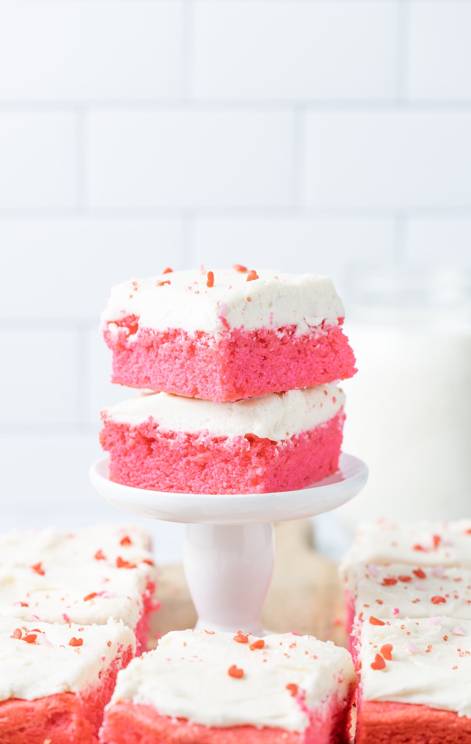 Two brownies stacked on top of one another on a stand.
