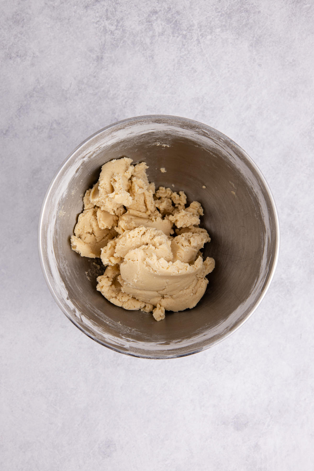 Butter, sugar, and egg mixed in a bowl.