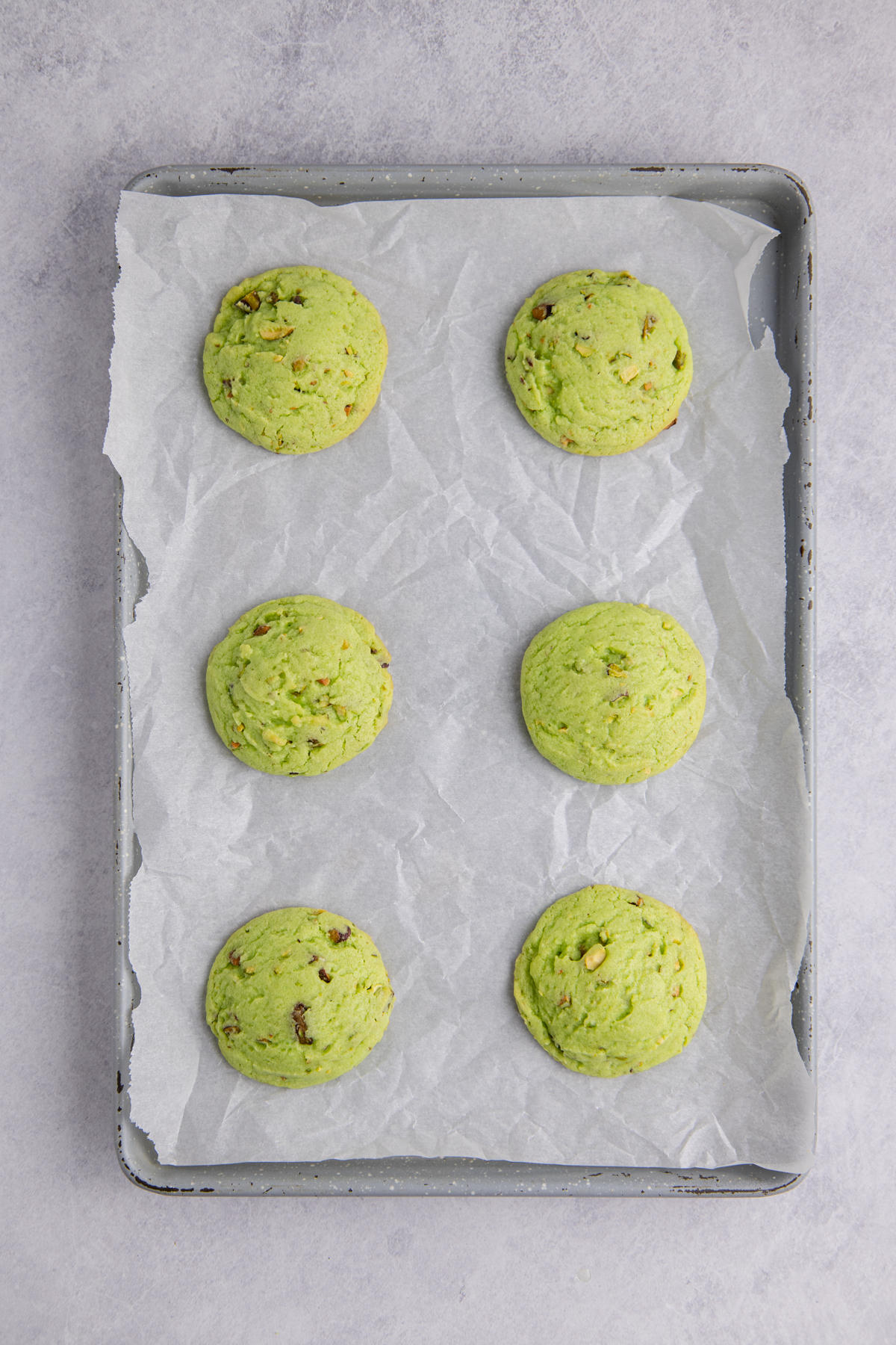Cookies cooked and cooling on a sheet pan.
