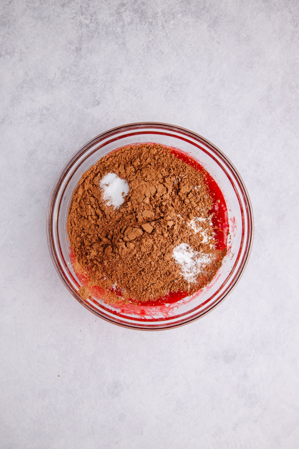 Dry ingredients added to the wet ingredients in a bowl.