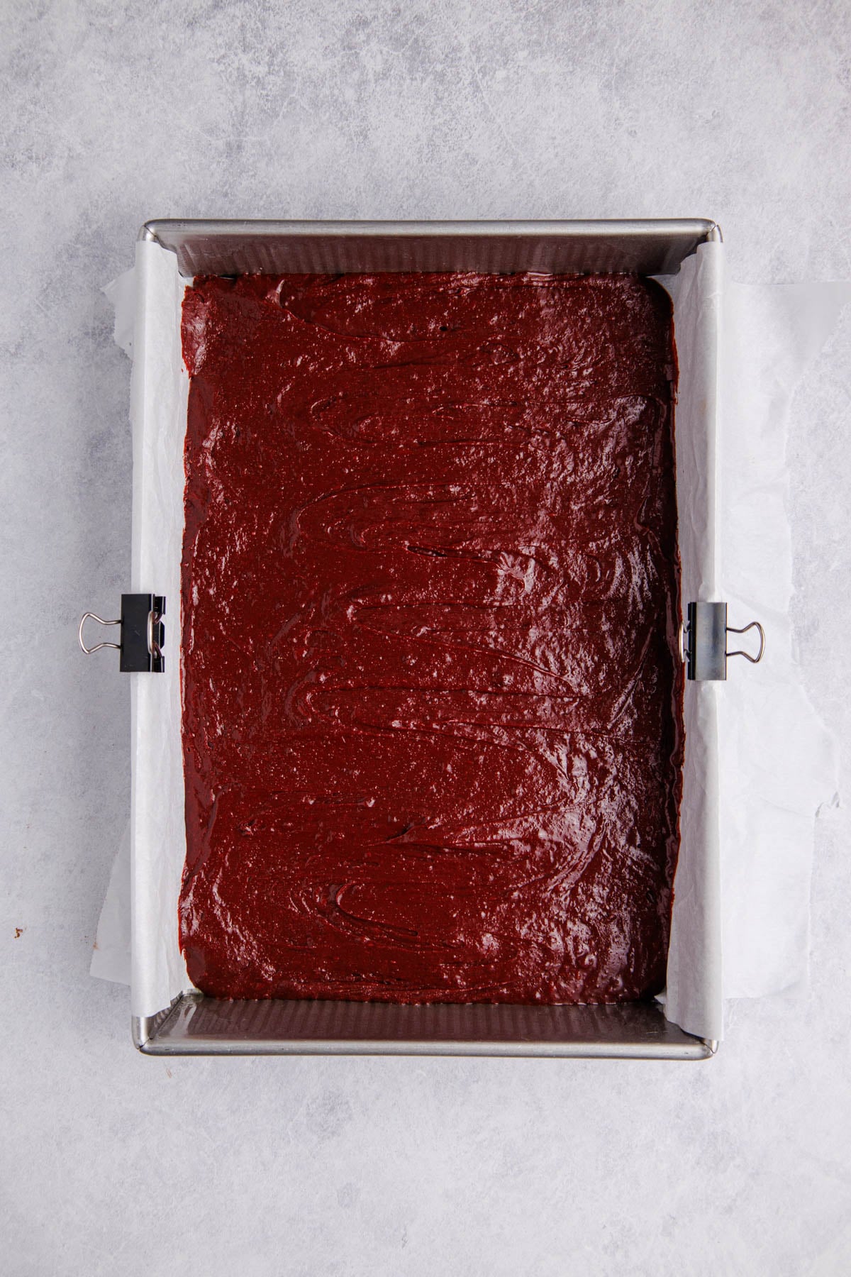 The brownie batter poured into the prepared baking pan.