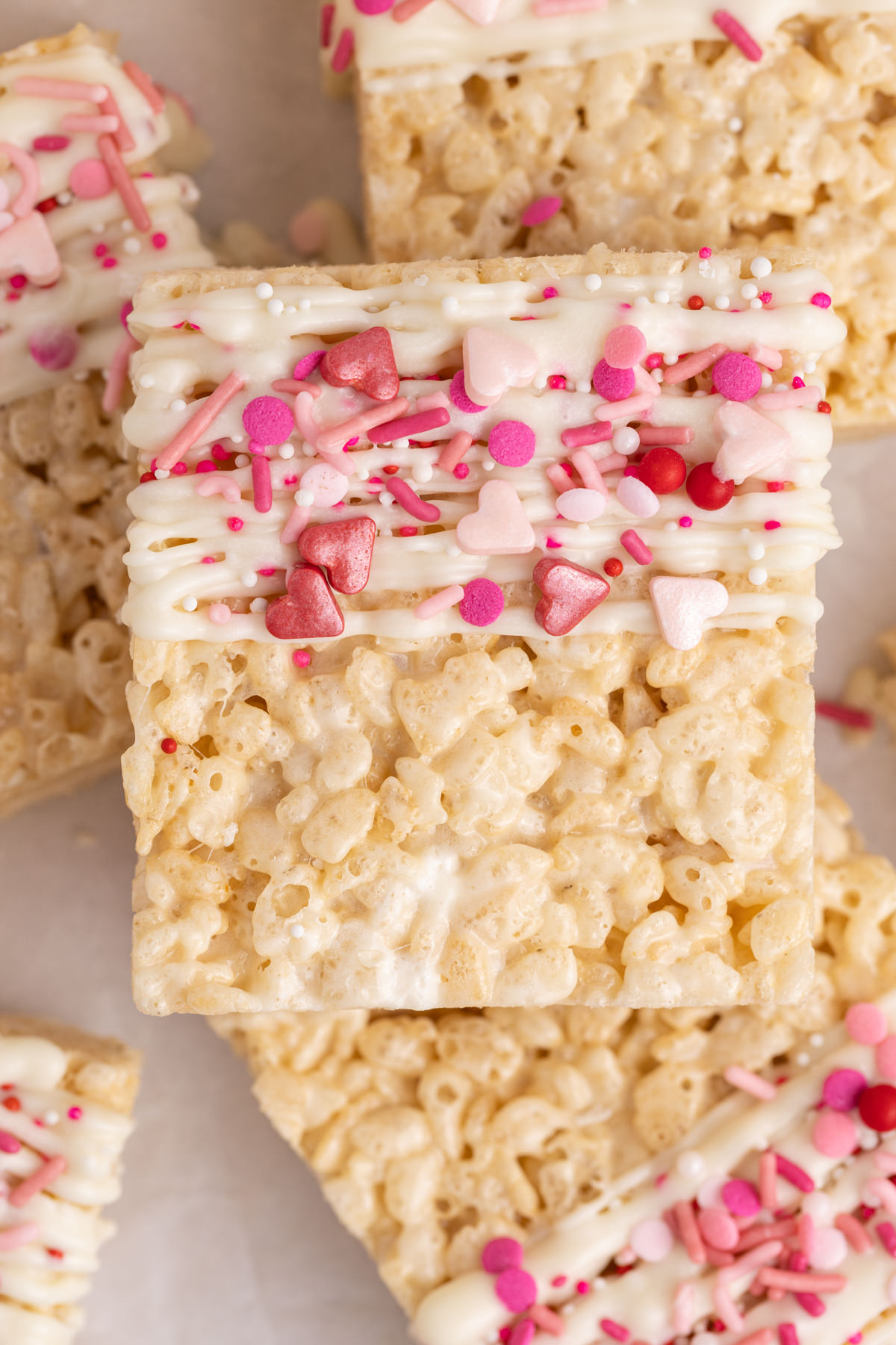Rice krispie squares on top of one another on a table.