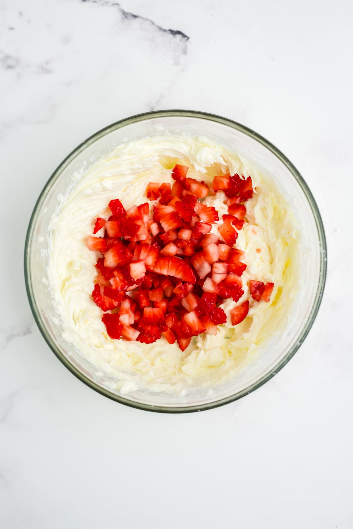 Diced strawberries in bowl with blended butter.