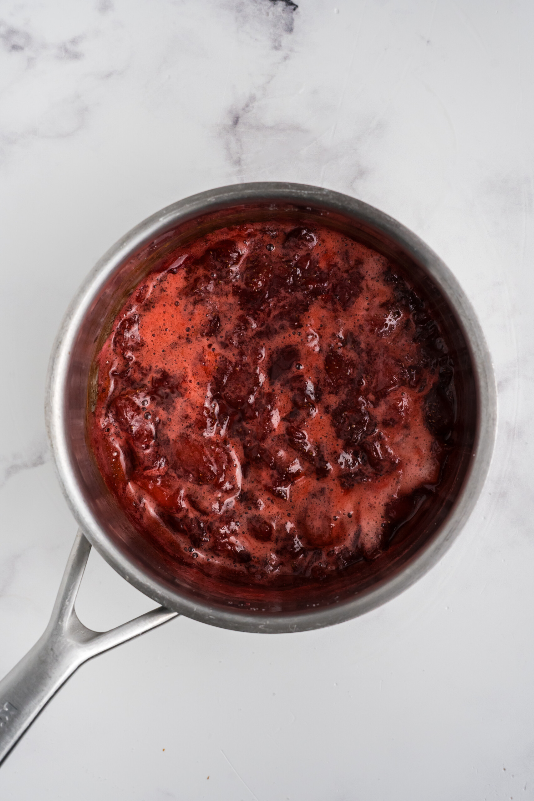Strawberries and sugar in a pot.