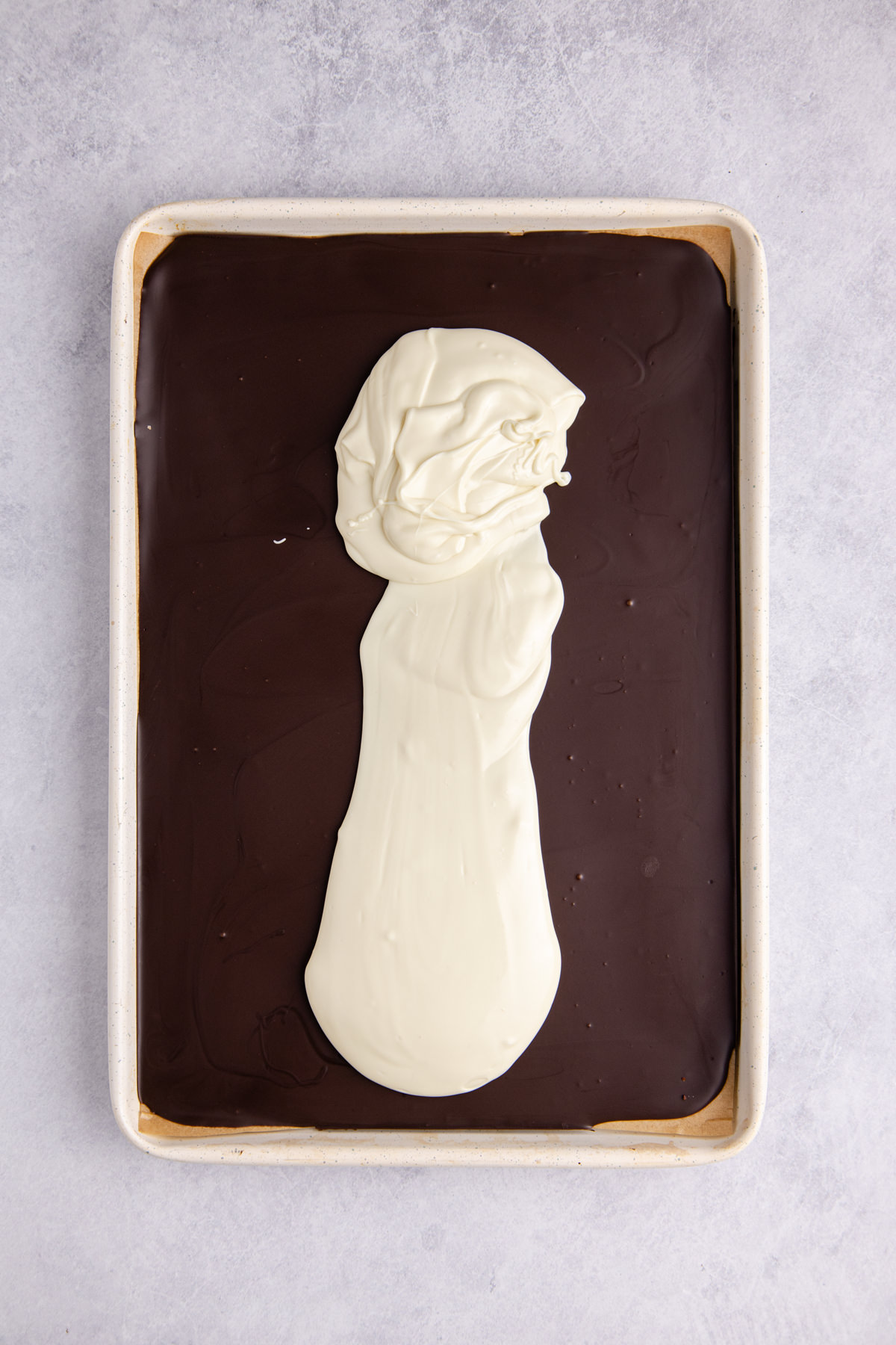 Melted white chocolate poured over top of the chilled chocolate layer.