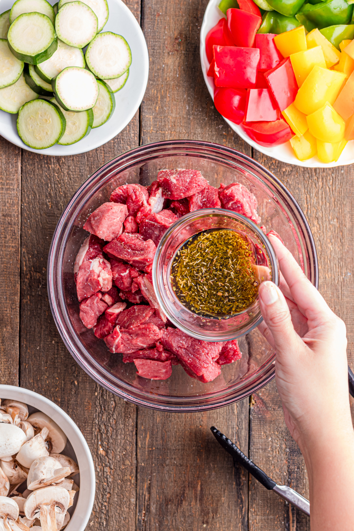 Marinade ingredients being added to the sirloin pieces.