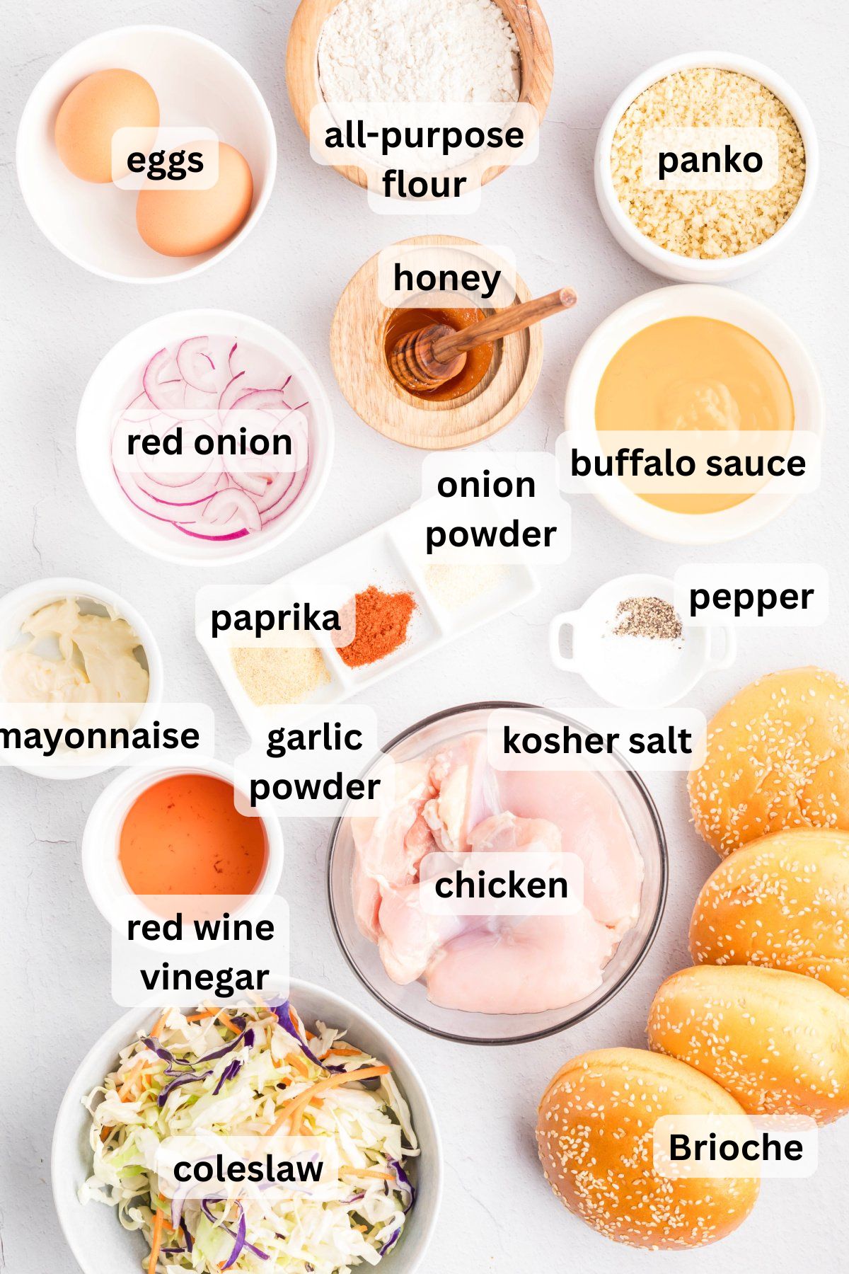 Ingredients to make this buffalo chicken sandwich in bowls on a table.