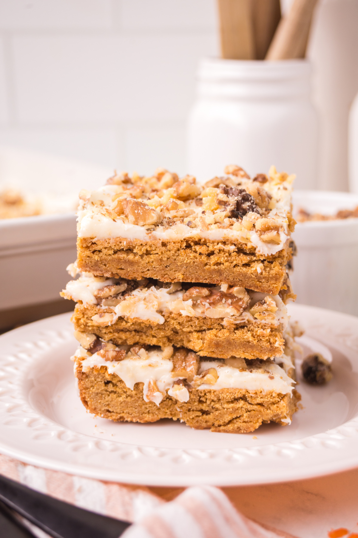 A stack of carrot cake blondies on a plate.