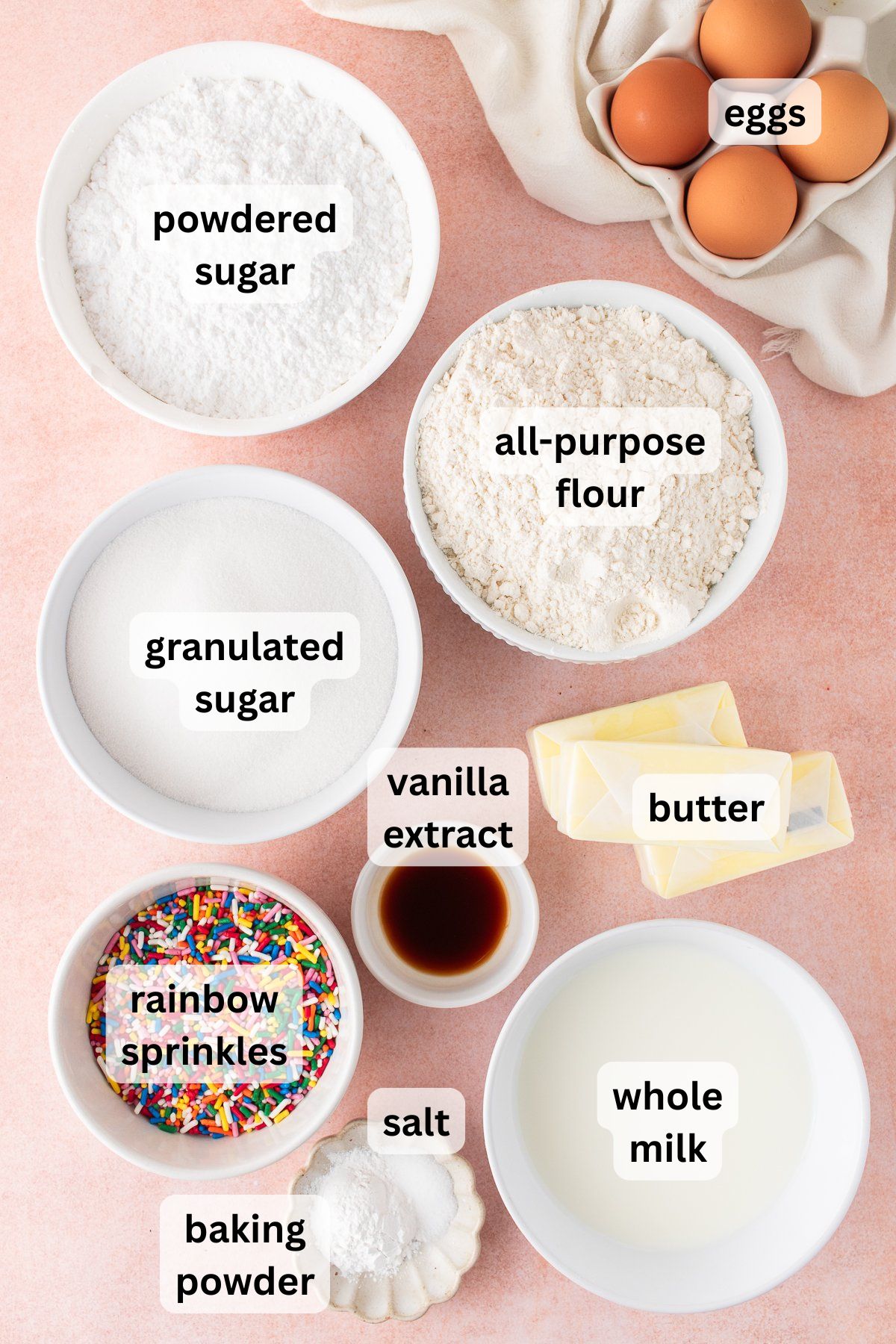 Ingredients to make this sprinkle bundt cake in bowls on a table.