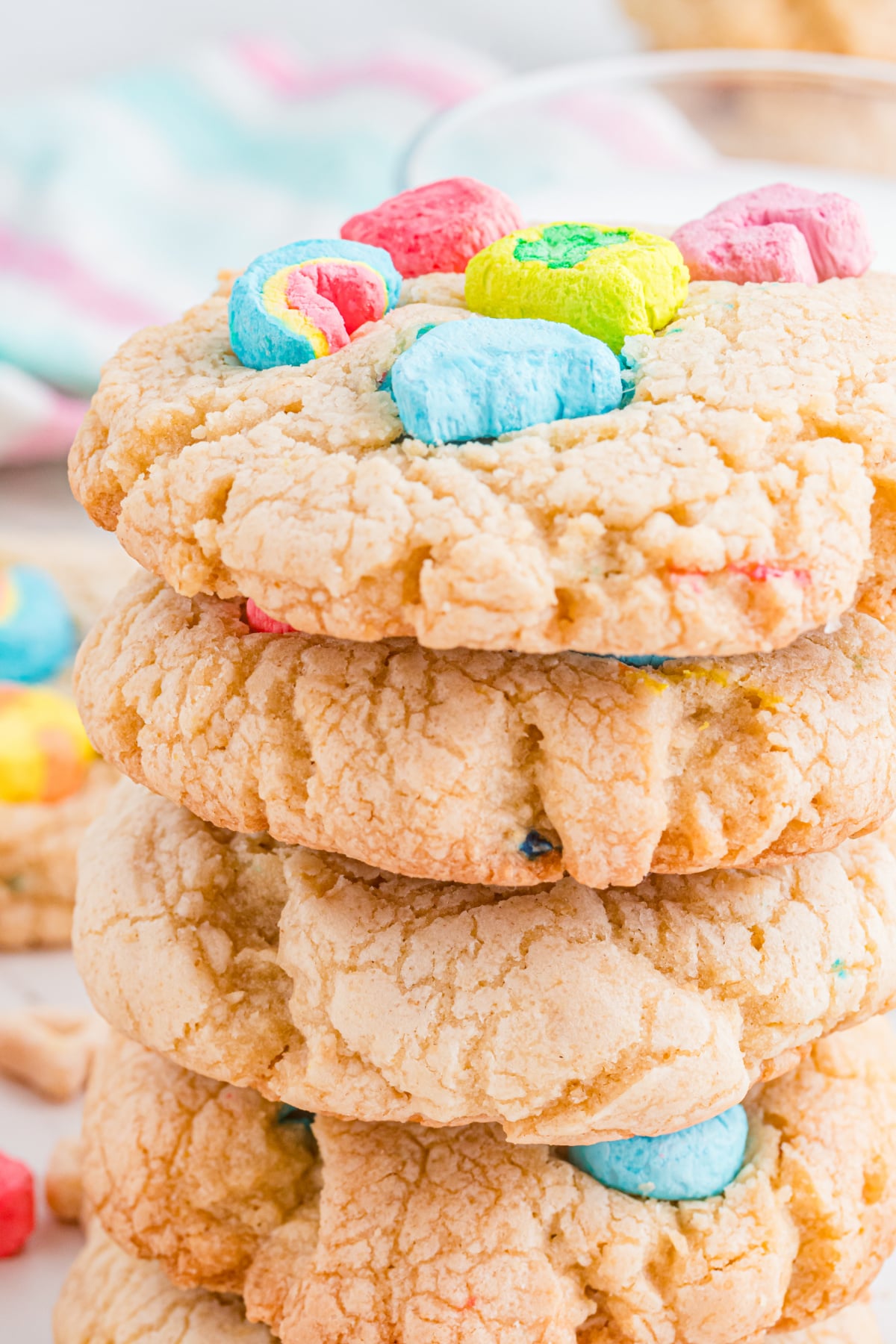 A stack of cookies with lucky charms marshmallows.