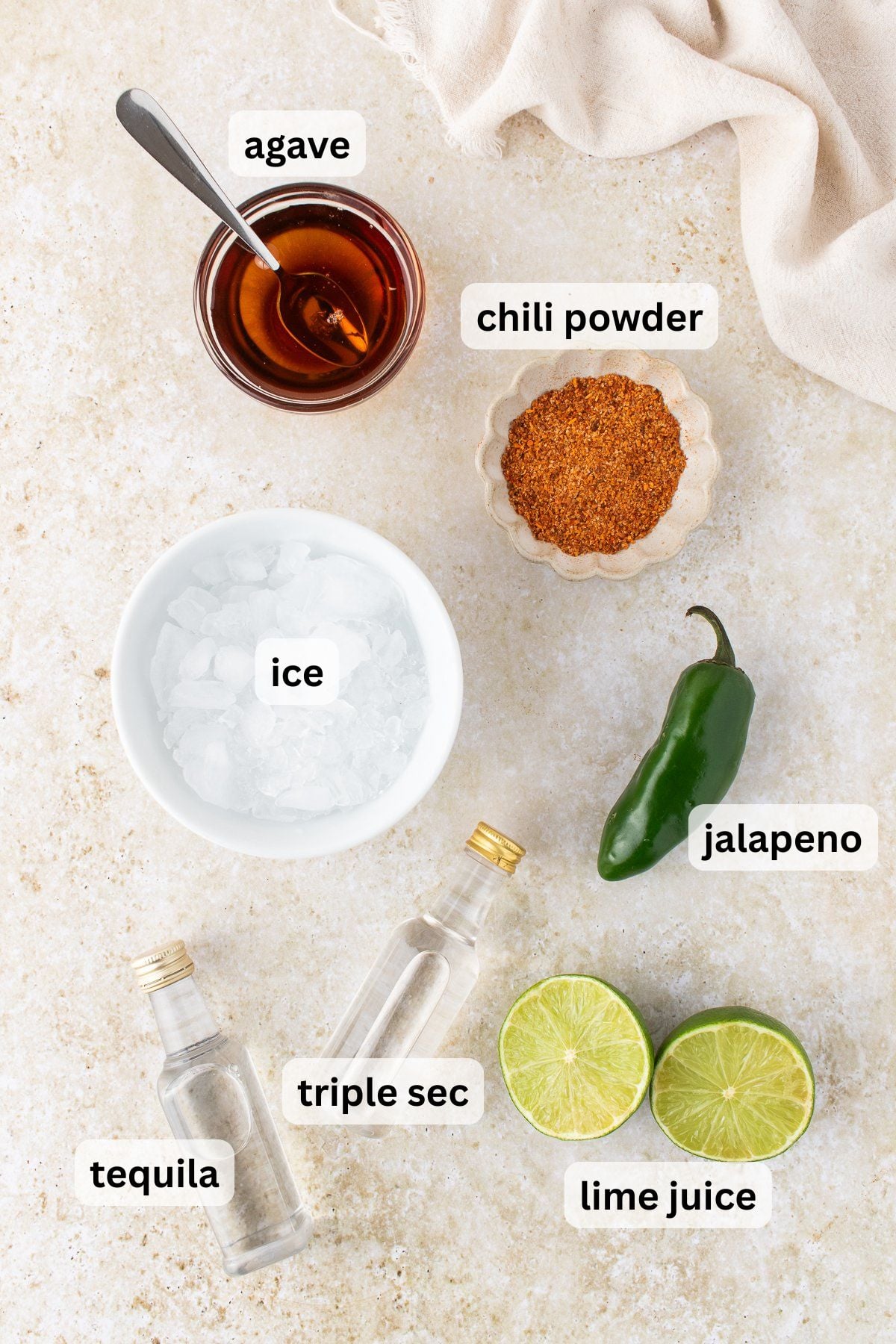 All of the ingredients needed to make a Spicy Jalape&ntilde;o Margarita on a table.