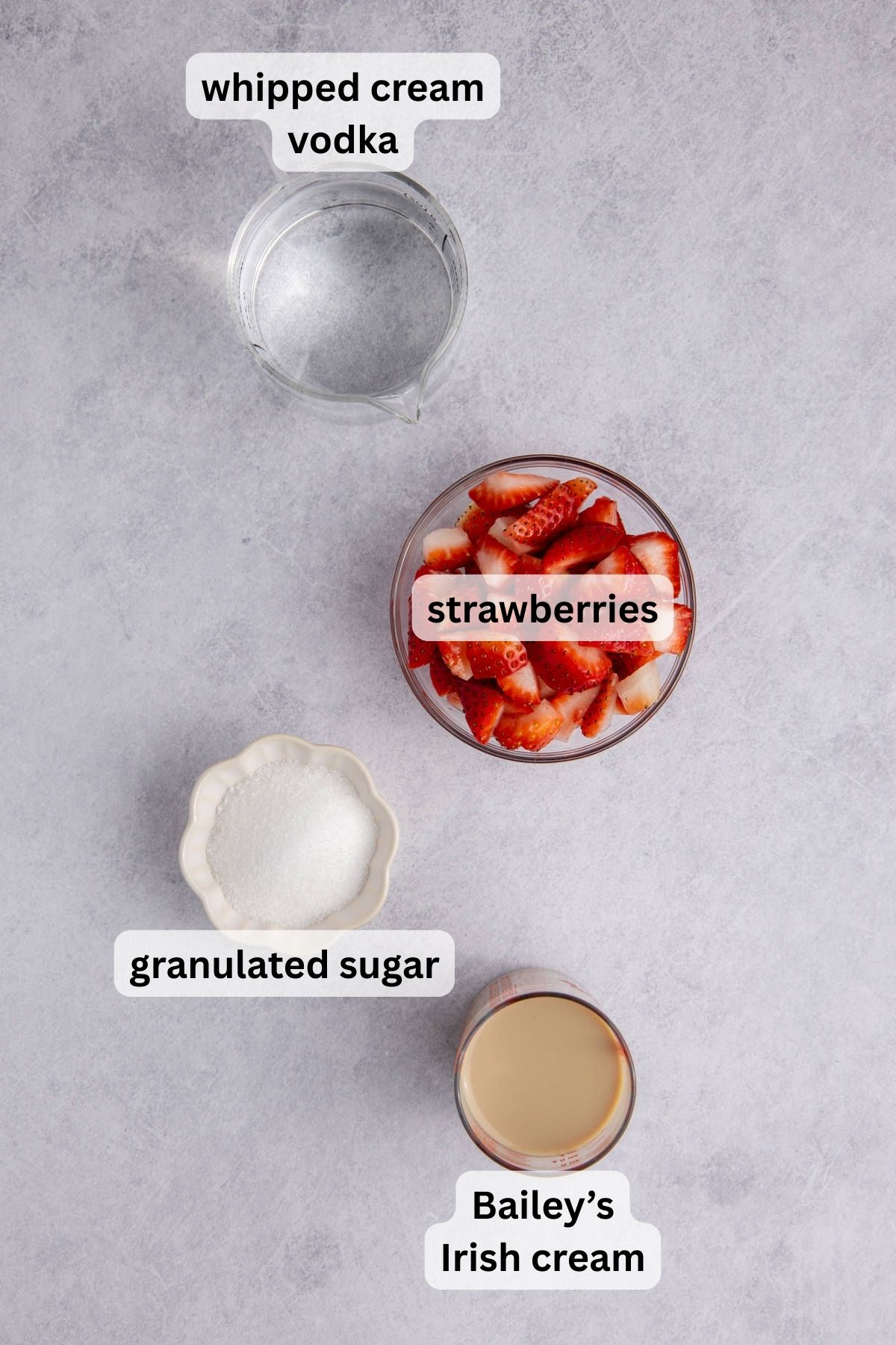 Ingredients for making strawberries and cream martini.