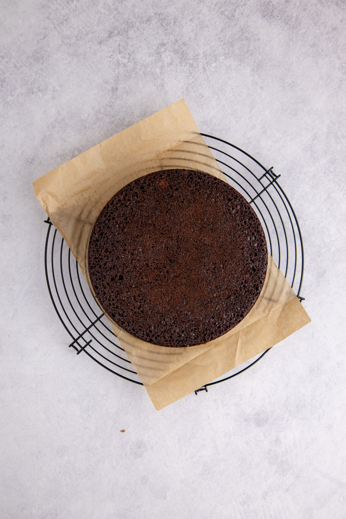 The cooled cake flipped onto parchment paper.