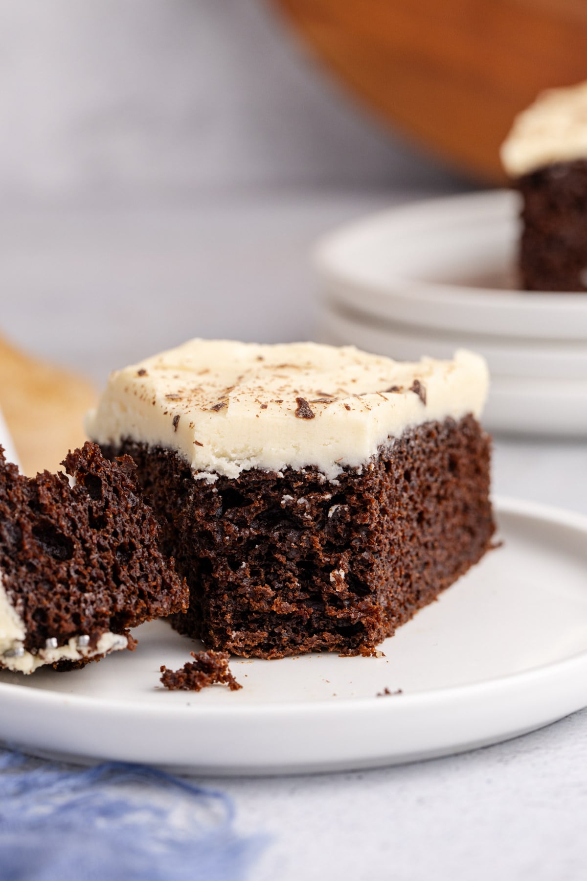 A piece of Irish cream cake with a bite taken off.