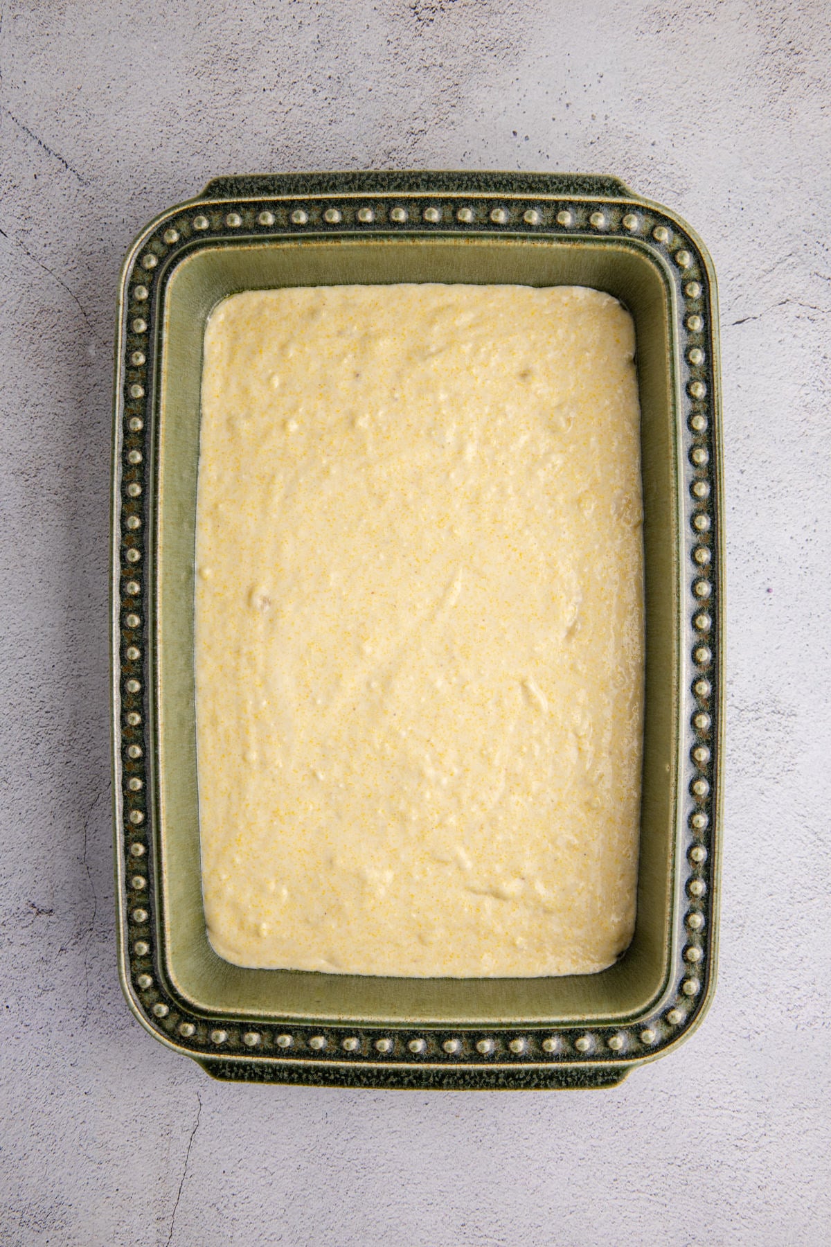 Ingredients for the banana cornbread poured into a baking dish.