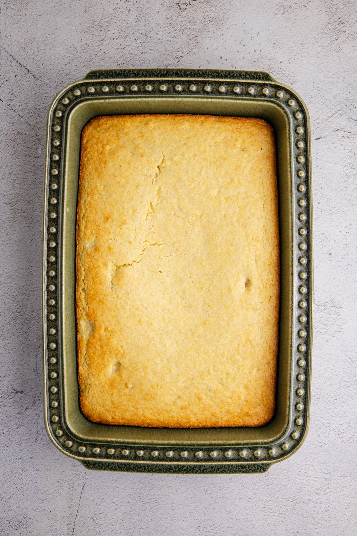 The cornbread baked in the baking dish.