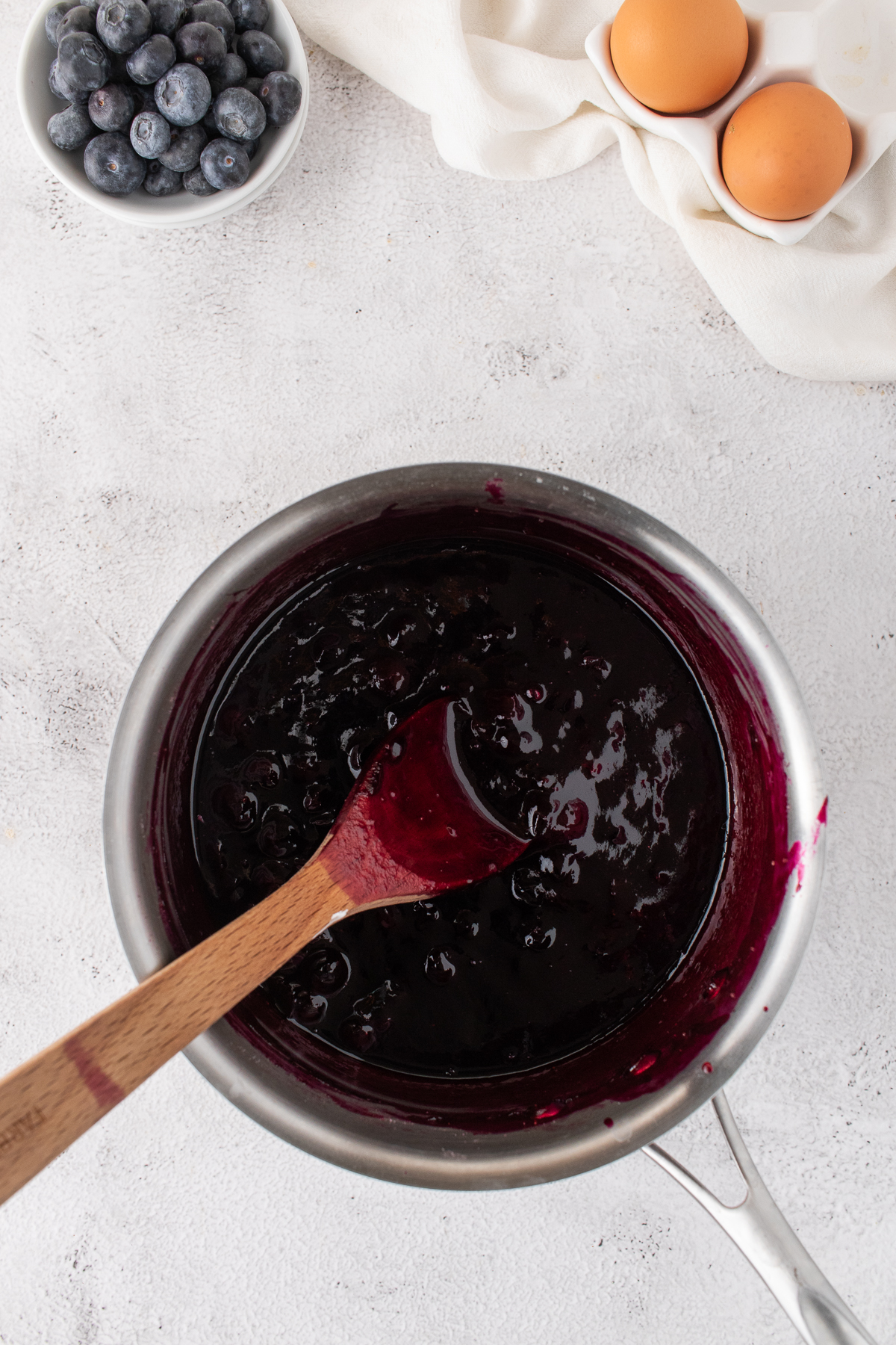 Blueberry jam mixture in a pot being made.
