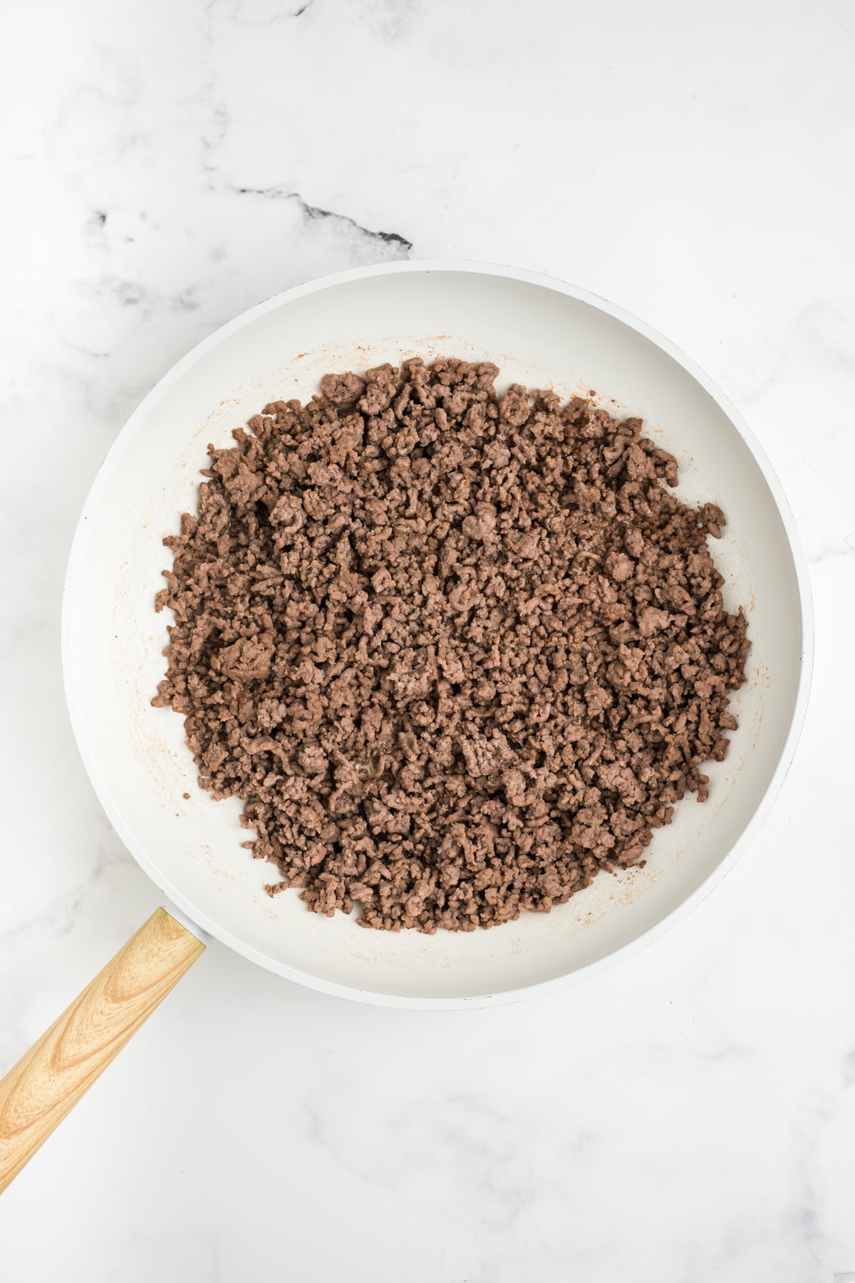 Cooked ground beef in a skillet.