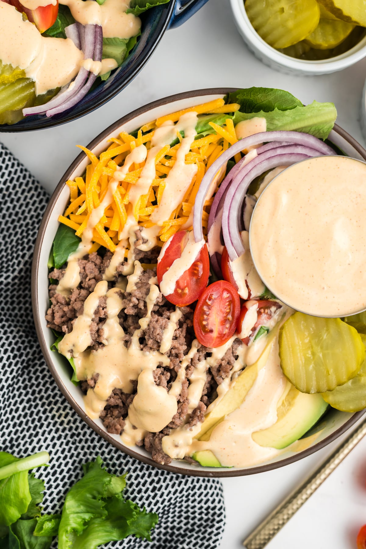 A burger bowl ready to eat on a table.