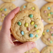 Cadbury mini egg cookies being held up in the air.