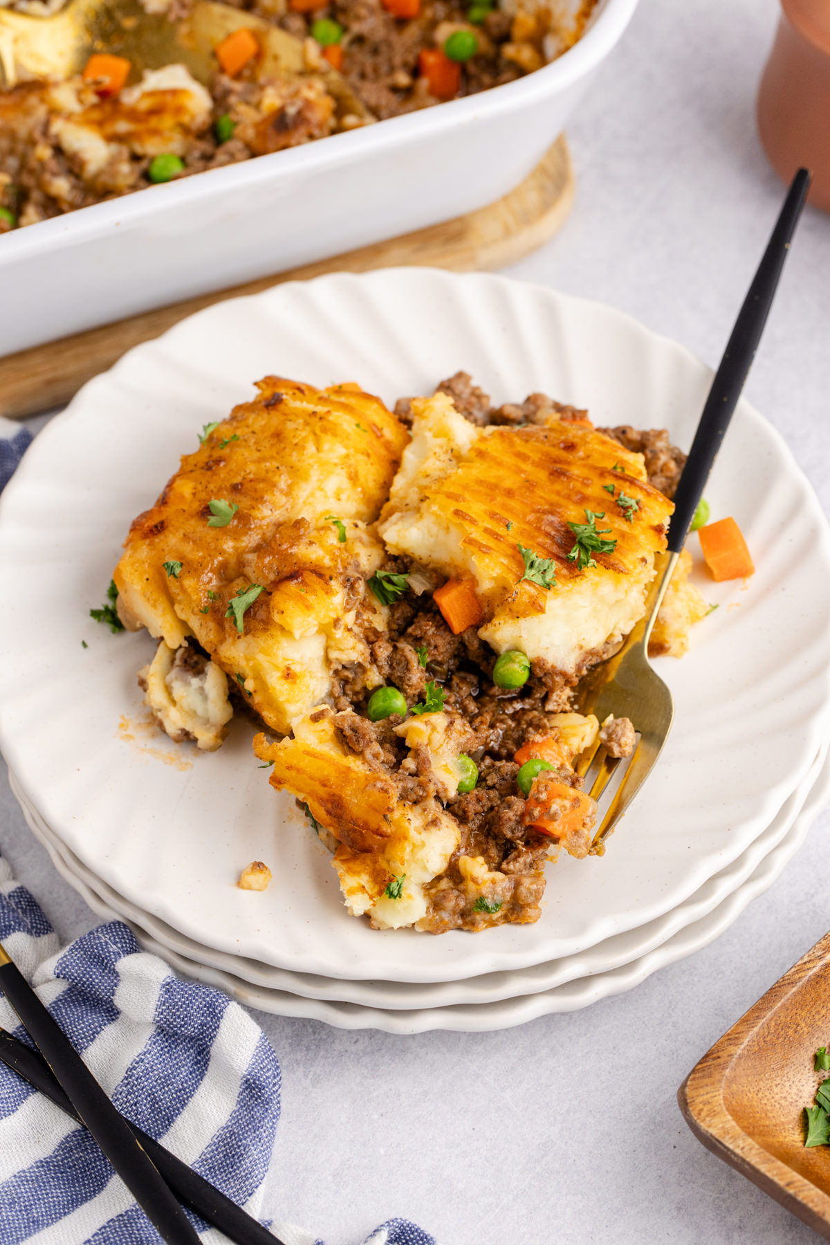 A plate full of cottage pie with a fork on the side.