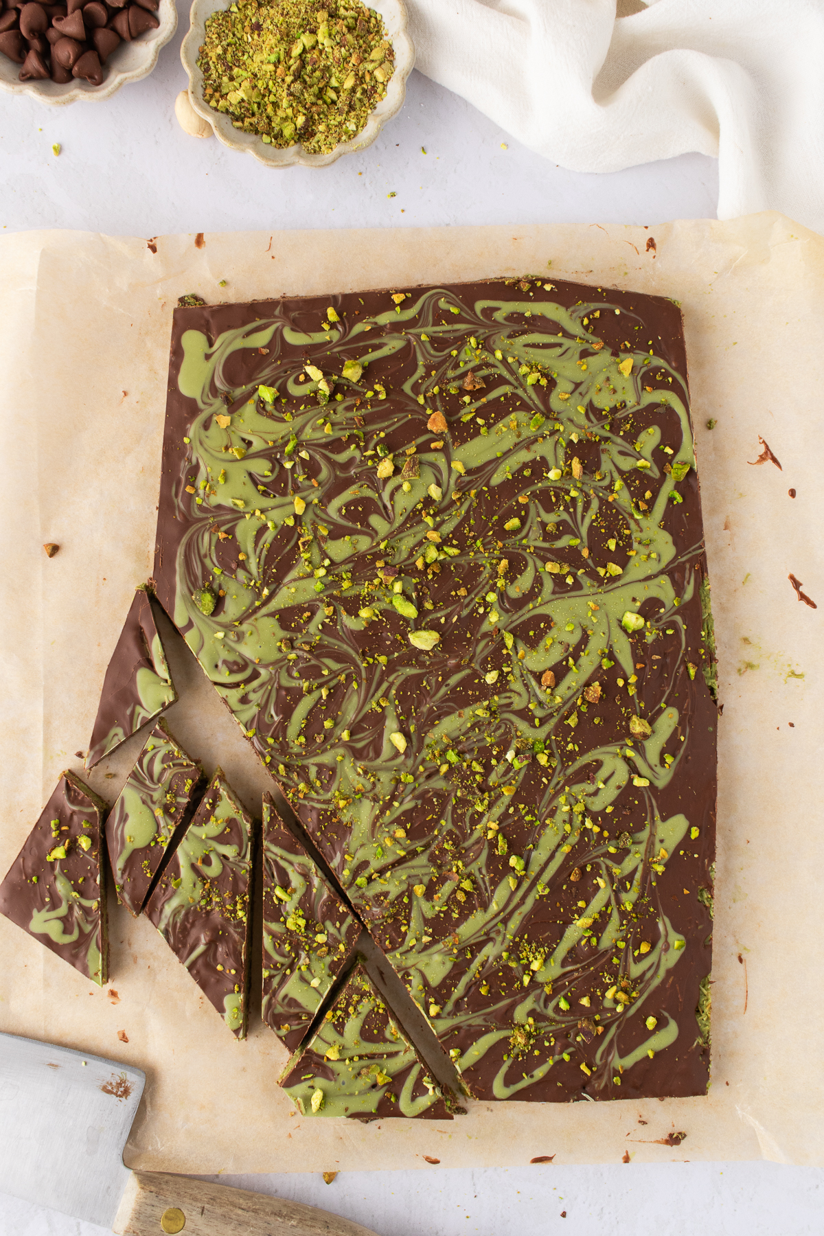Pistachio swirl is added on top of top chocolate layer with chopped pistachios.