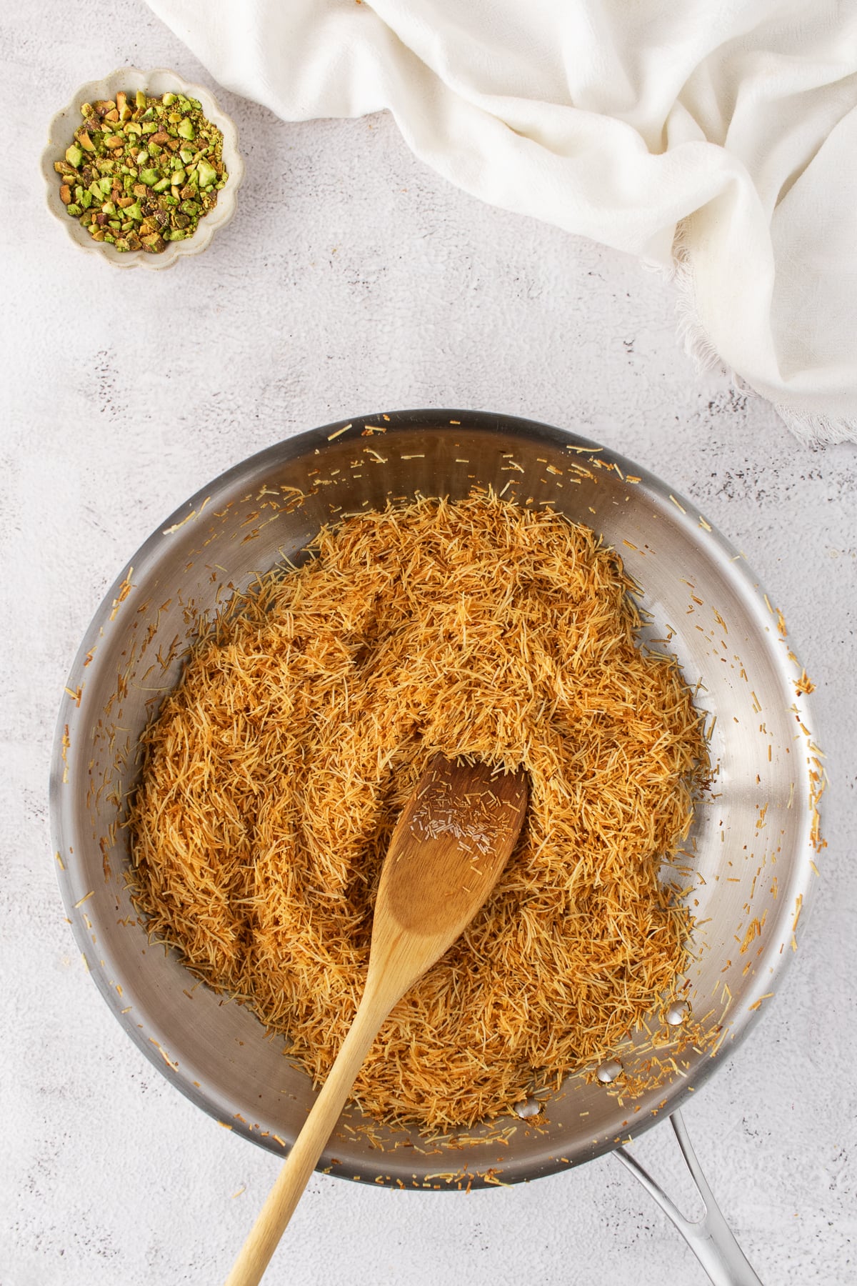 Kataifi toasted in a skillet.