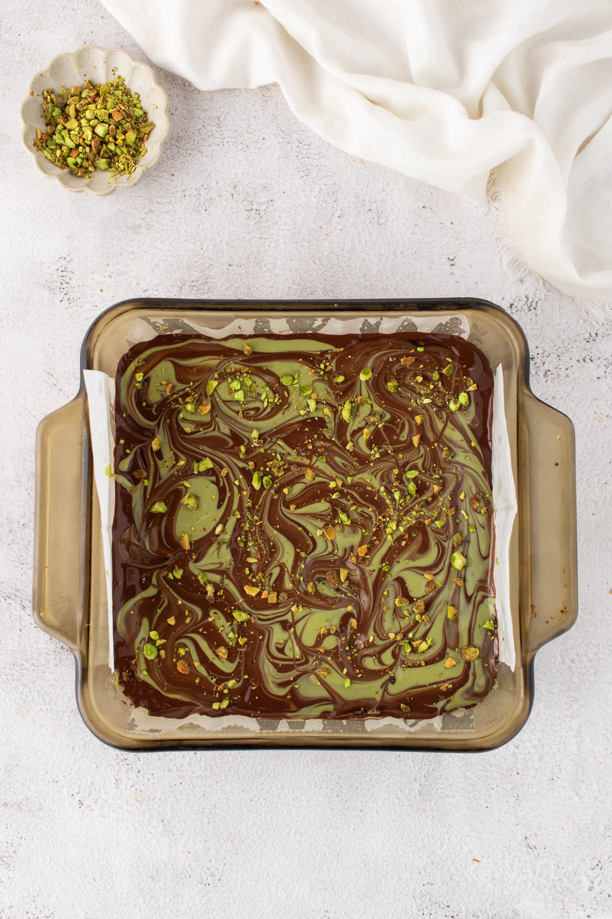 Pistachio cream added to the white chocolate poured and swirled.