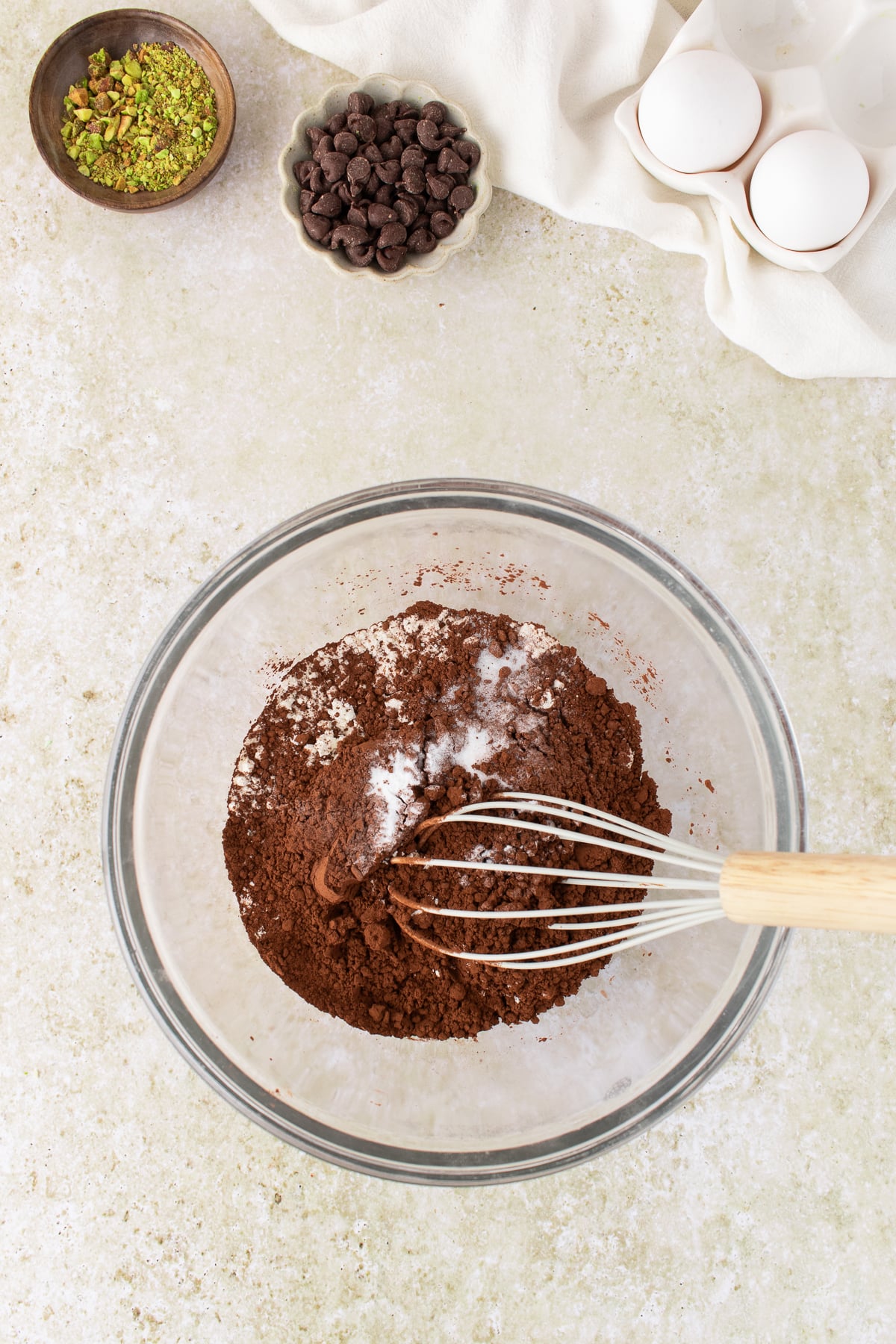 Dry ingredients in a mixing bowl with a whisk.