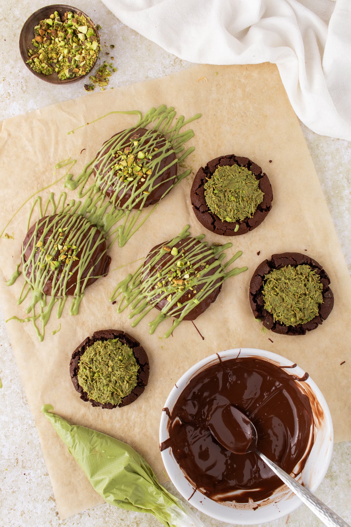 Filling added to the cookies then melted chocolate drizzled on top.