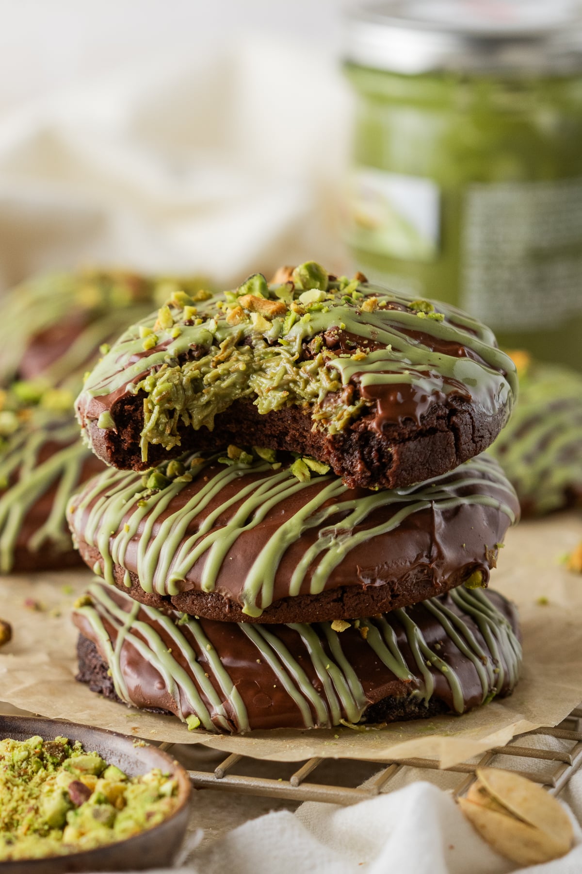 A stack of Dubai chocolate cookies with a bitten cookie on top.
