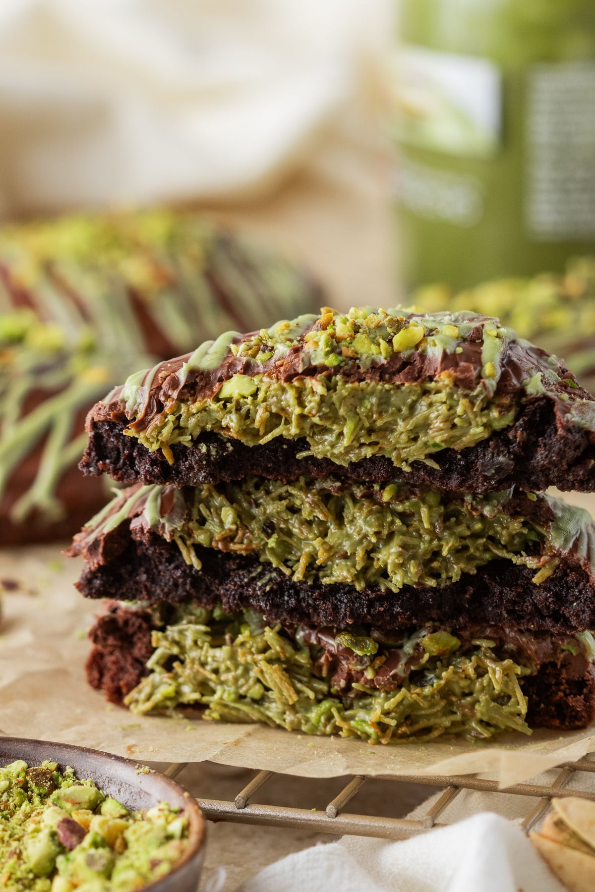 A stack of Dubai chocolate cookies broken in half to show the inside.