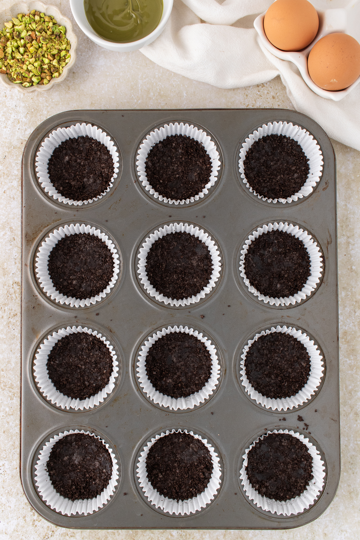 Crushed Oreos with melted butter pressed into the liner.