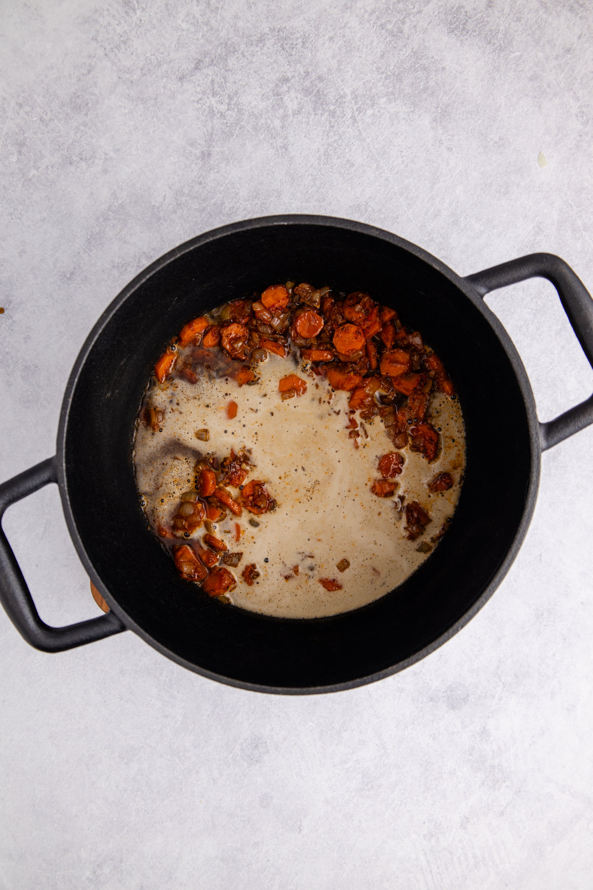 Guinness, Carrots and onions added to the dutch oven.