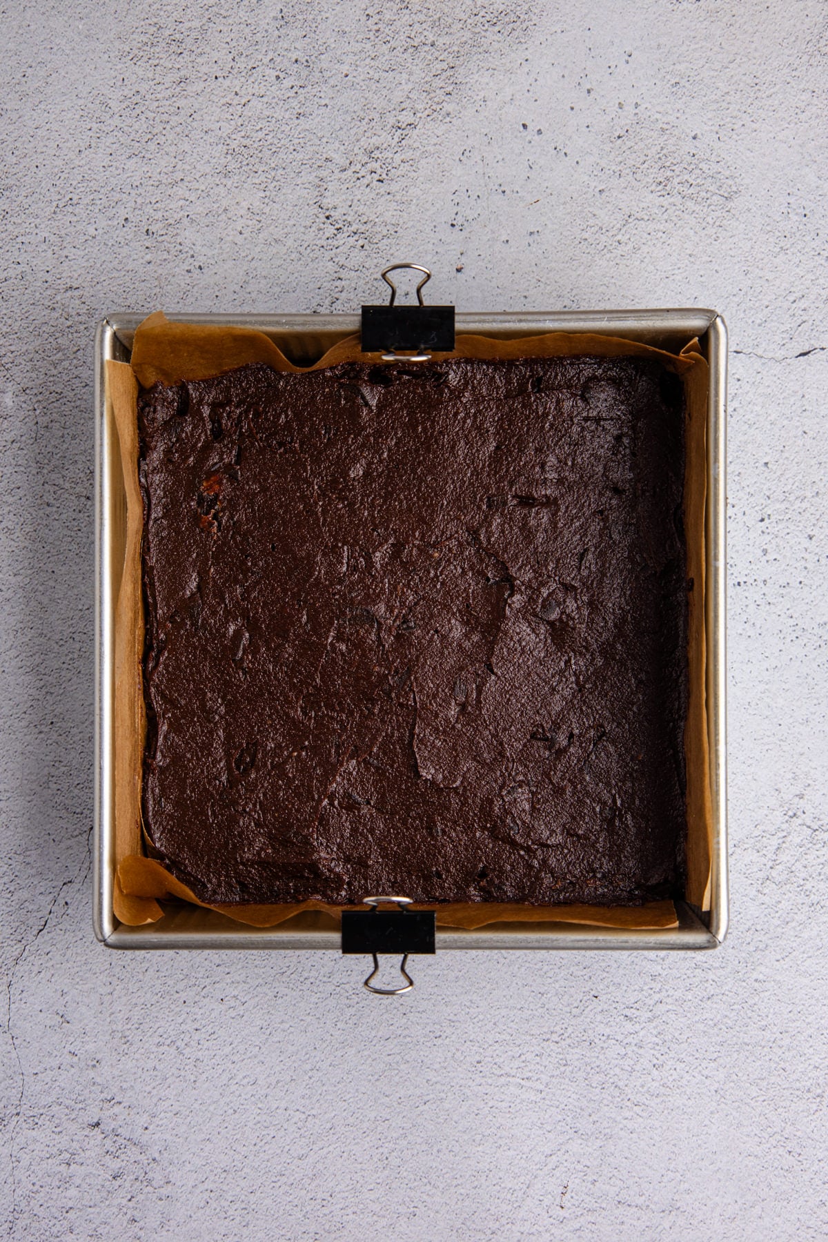 The brownie batter transferred to a baking pan.