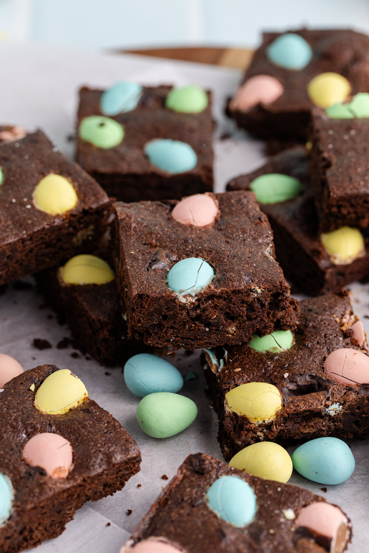 Brownies with chocolate easter eggs sliced on a table.