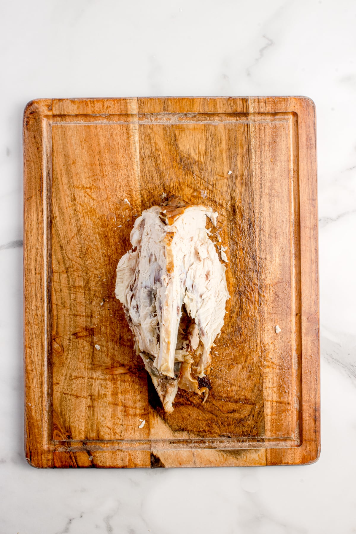 The resulting carcass on a cutting board.