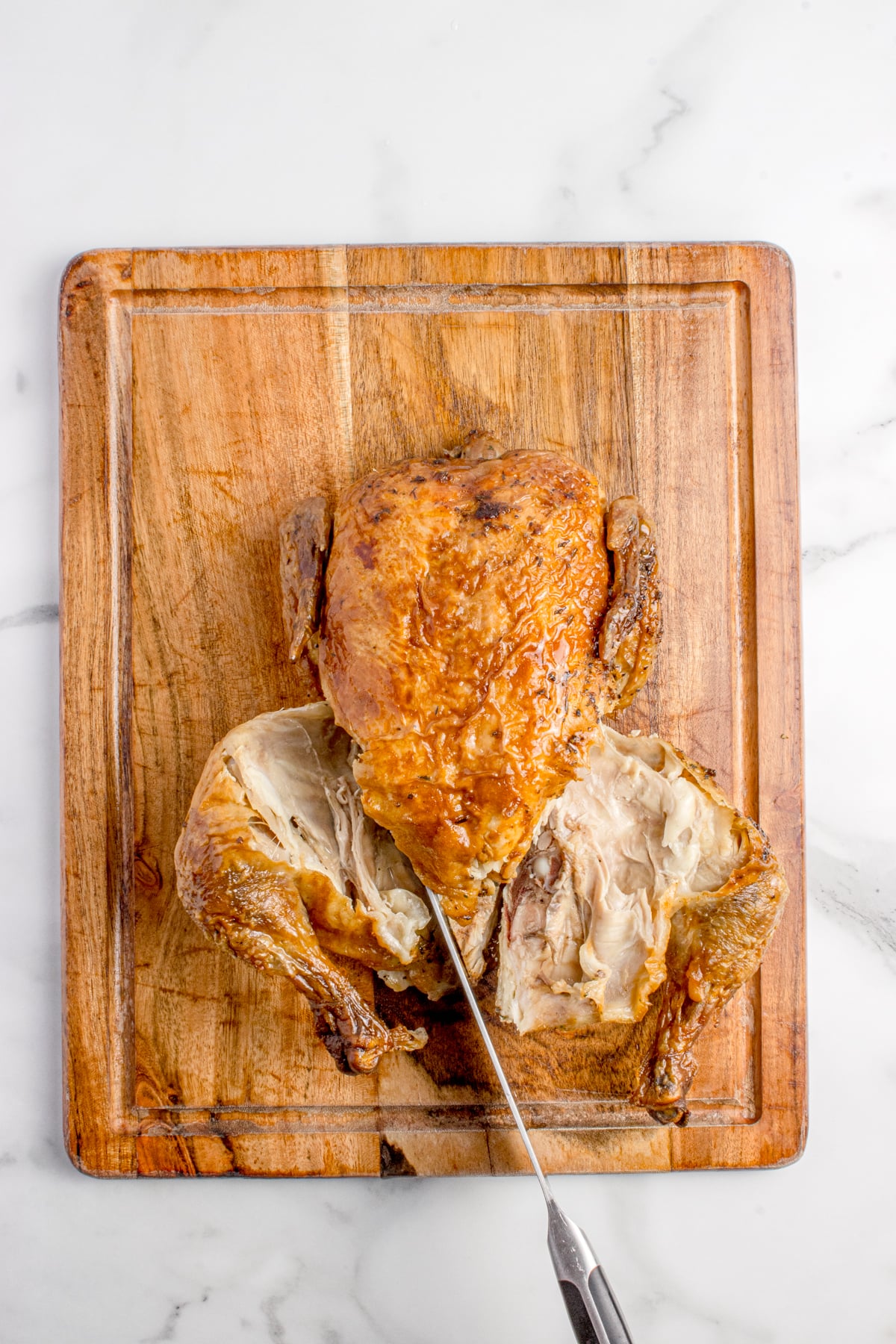 Both legs are removed from chicken.